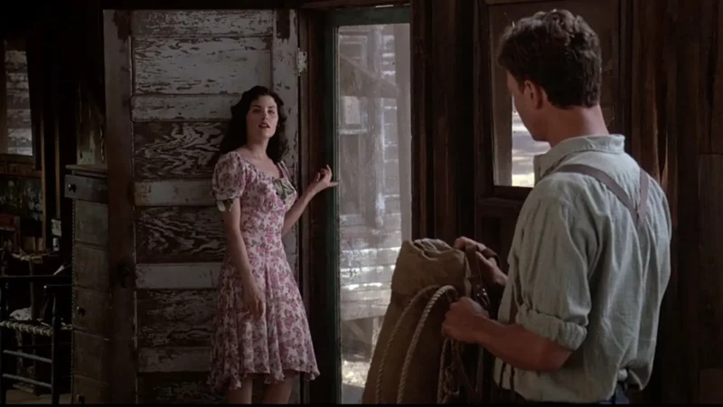 Curley's Wife stands at the door