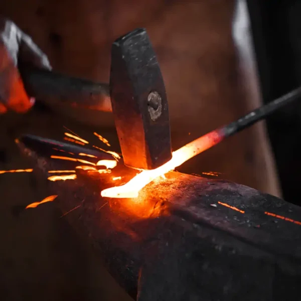 blacksmith hammering metal