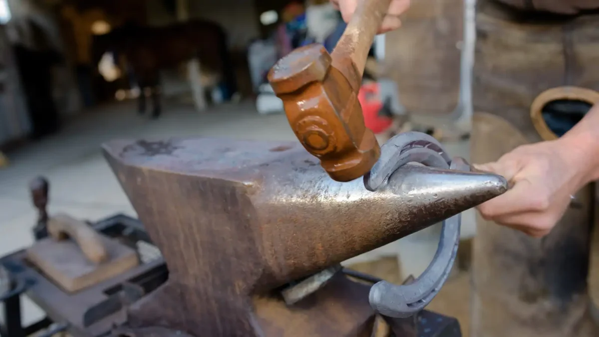 blacksmith shaping a horseshoe